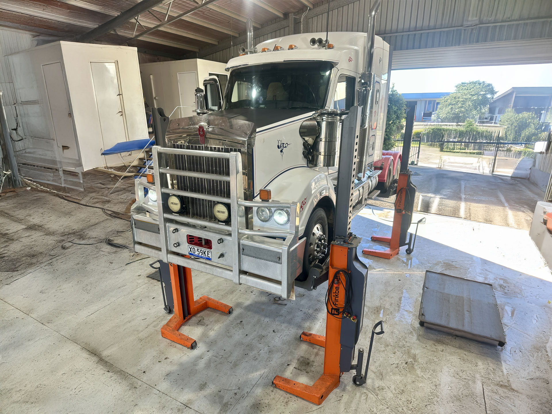 Kenworth Truck Raised on Workshop Hoists for Heavy Diesel Servicing — Toowoomba Heavy Diesel in Harristown, QLD
